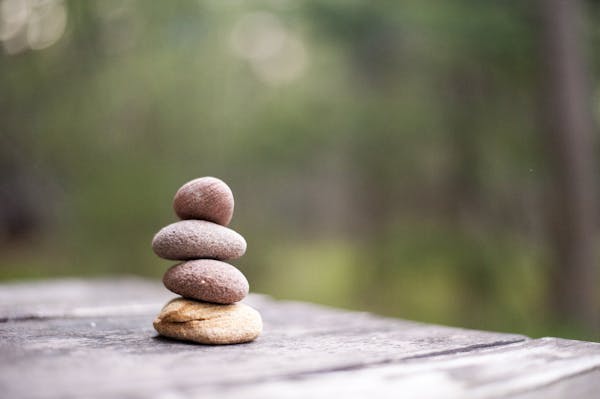 Balance and tranquility embodied by stacked stones in a natural outdoor setting.