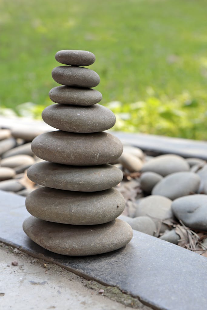 A harmonious pile of carefully balanced stones in a tranquil outdoor setting.